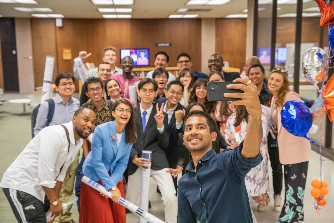 A group of people taking a selfie.